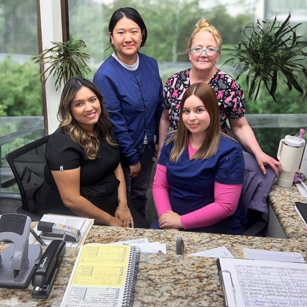 Front Office Ladies Sitting At Desk